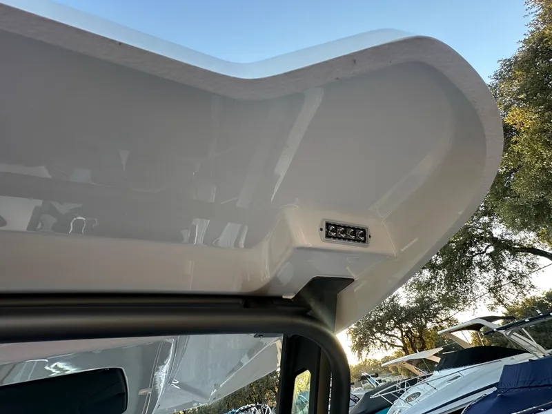 Slide: The Image of 2025 Monterey Elite 30 OB boat canopy detail with clear sky background. - 88