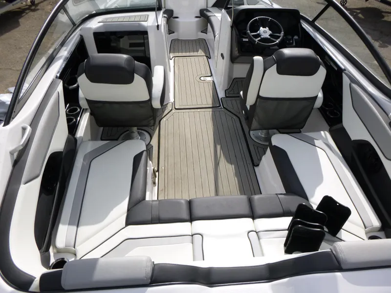 Slide: The Image of 2021 Yamaha Boats 212S interior with sleek seating and modern dashboard design. - 11