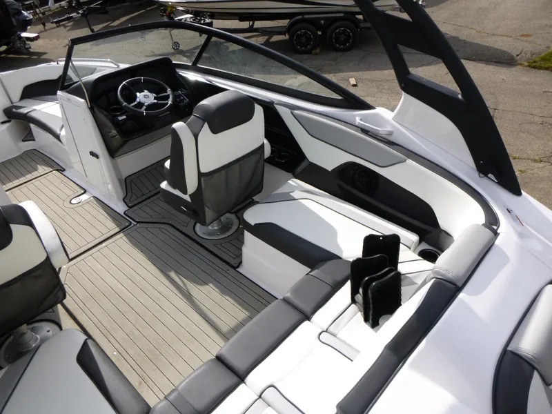 Slide: The Image of 2021 Yamaha Boats 212S interior with sleek seating and modern dashboard design. - 14