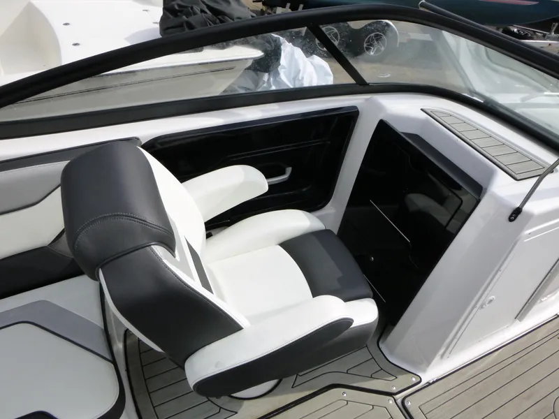 Slide: The Image of 2021 Yamaha Boats 212S interior with sleek black and white seating. - 15