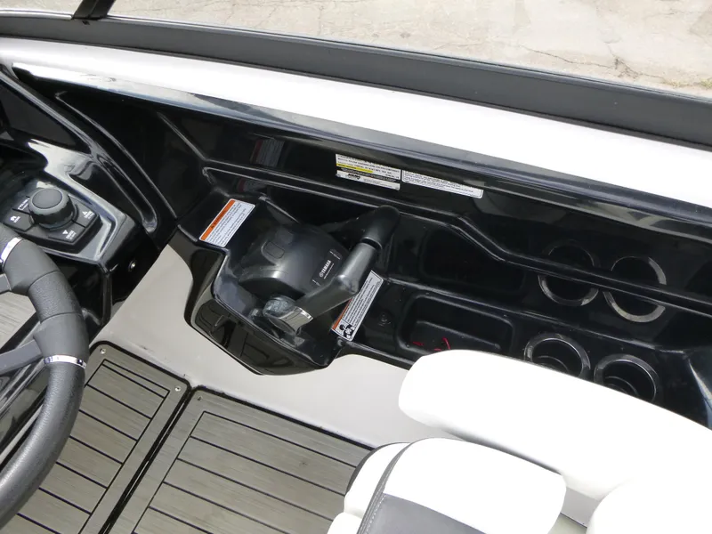 Slide: The Image of 2021 Yamaha Boats 212S cockpit with steering wheel and controls. - 17