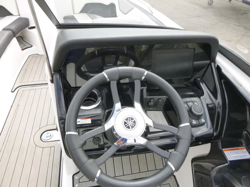 Slide: The Image of 2021 Yamaha Boats 212S steering wheel and dashboard, featuring modern controls and sleek design. - 18