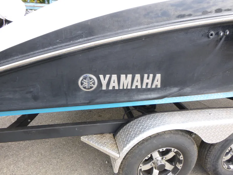 Slide: The Image of 2021 Yamaha Boats 212S on trailer, side view with logo visible. - 23