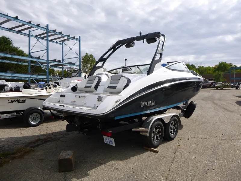 Slide: The Image of 2021 Yamaha Boats 212S on trailer in marina parking lot. - 8