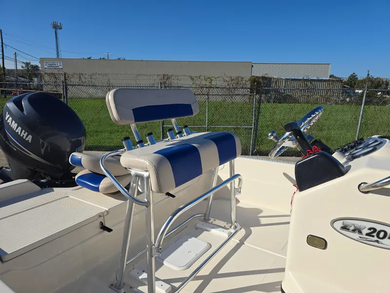 Slide: The Image of 2009 Skeeter ZX 20 Bay boat interior with Yamaha engine and blue-striped seating. - 12
