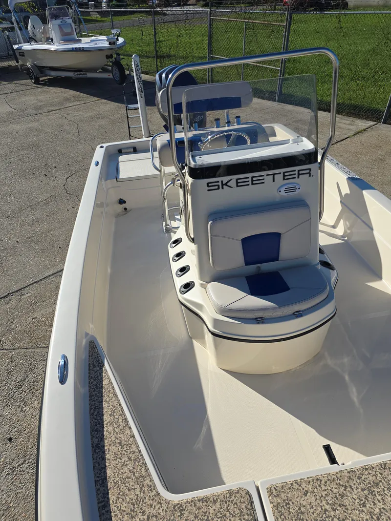 Slide: The Image of 2009 Skeeter ZX 20 Bay boat with center console and seating, parked on concrete. - 13