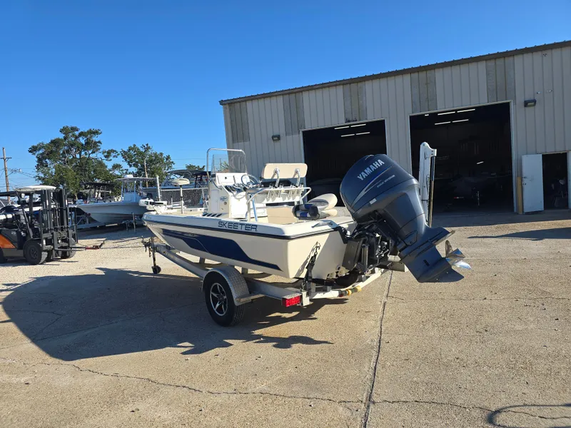 Slide: The Image of 2009 Skeeter ZX 20 Bay boat with Yamaha outboard motor in a marina setting. - 5