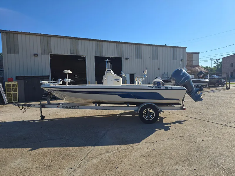 Slide: The Image of 2009 Skeeter ZX 20 Bay boat on trailer outside a warehouse. - 6