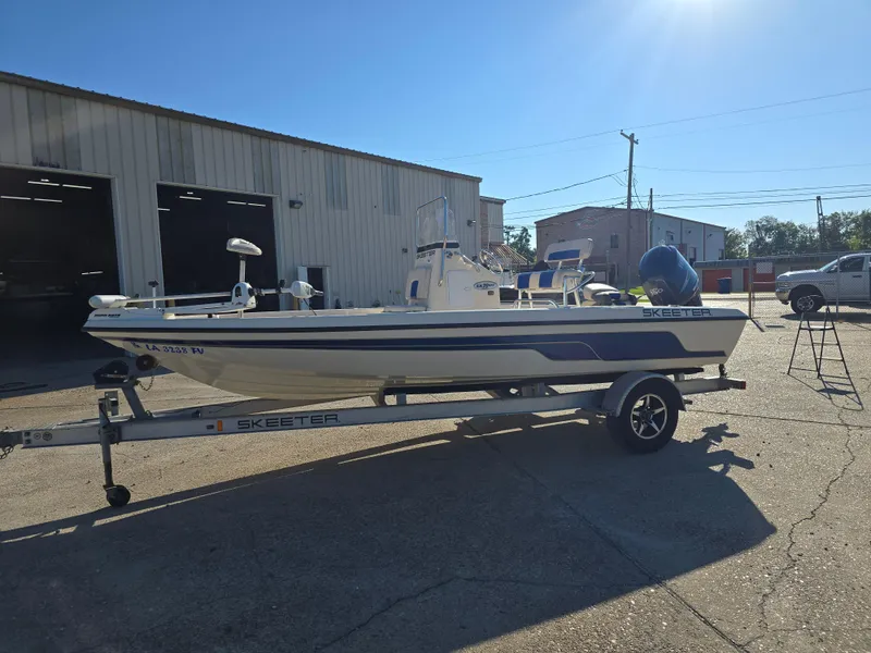 Slide: The Image of 2009 Skeeter ZX 20 Bay boat on trailer outside a warehouse. - 7