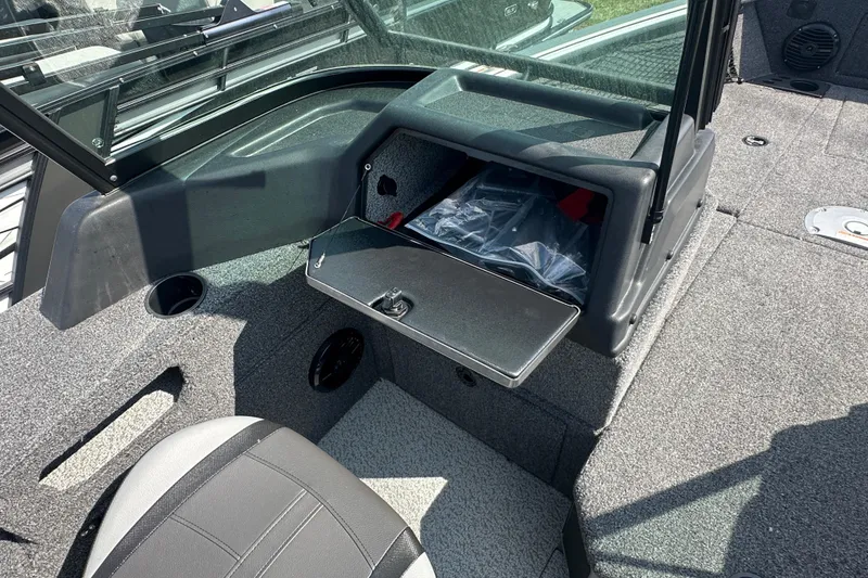 Slide: The Image of 2025 Lund 1775 Impact XS Sport boat interior with open storage compartment. - 18