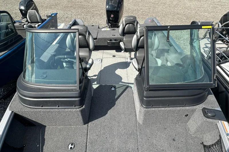 Slide: The Image of 2025 Lund 1775 Impact XS Sport boat interior with dual consoles and seating. - 20