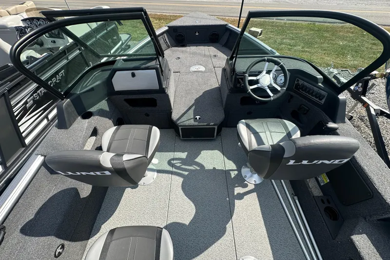 Slide: The Image of 2025 Lund 1775 Impact XS Sport boat interior with seating and steering console. - 21