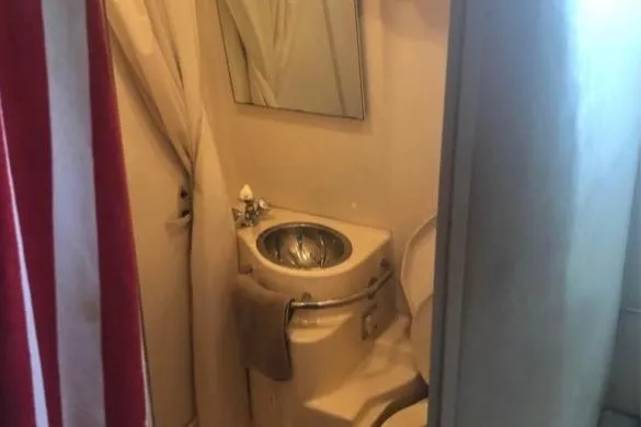 Slide: The Image of Compact bathroom in 1998 Sea Ray 310 boat with sink and mirror. - 11
