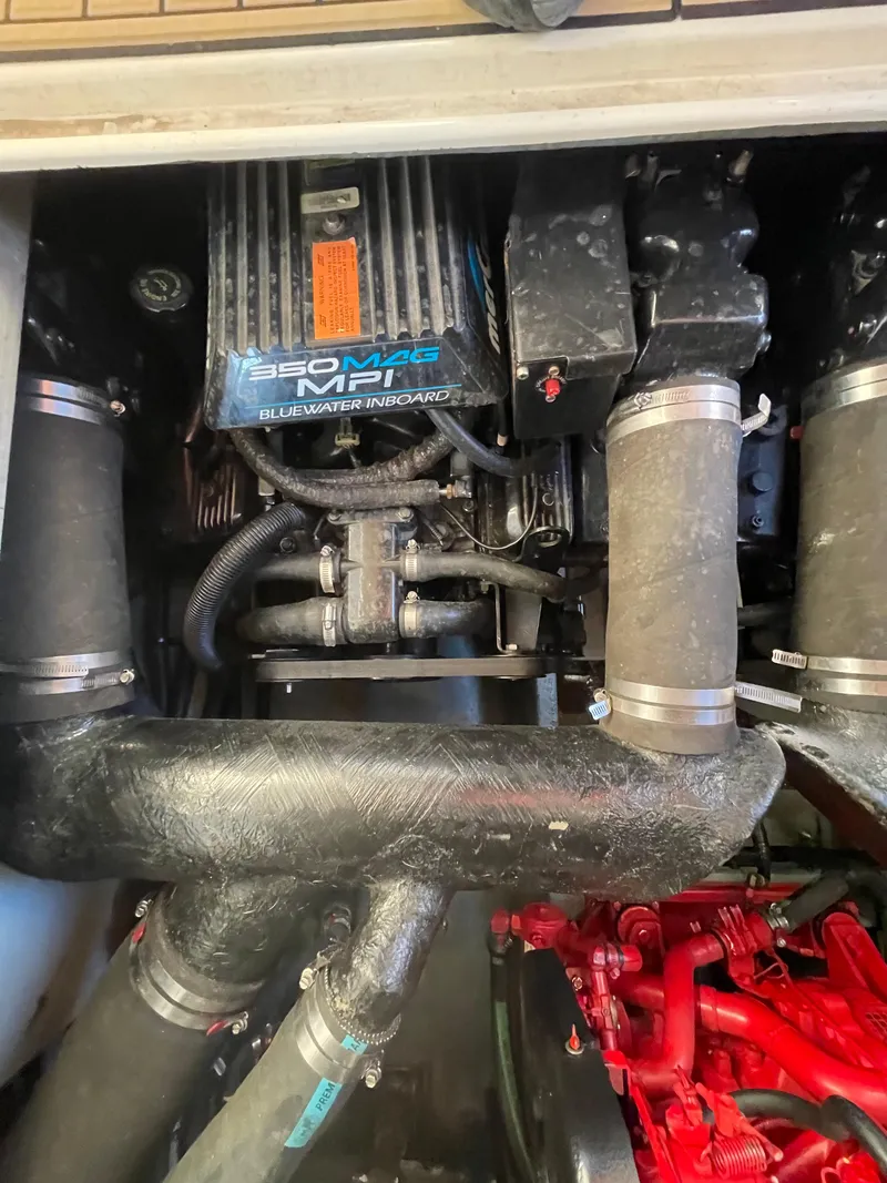 Slide: The Image of Engine compartment of a 1998 Sea Ray 310 boat, featuring a 350 MPI motor. - 15