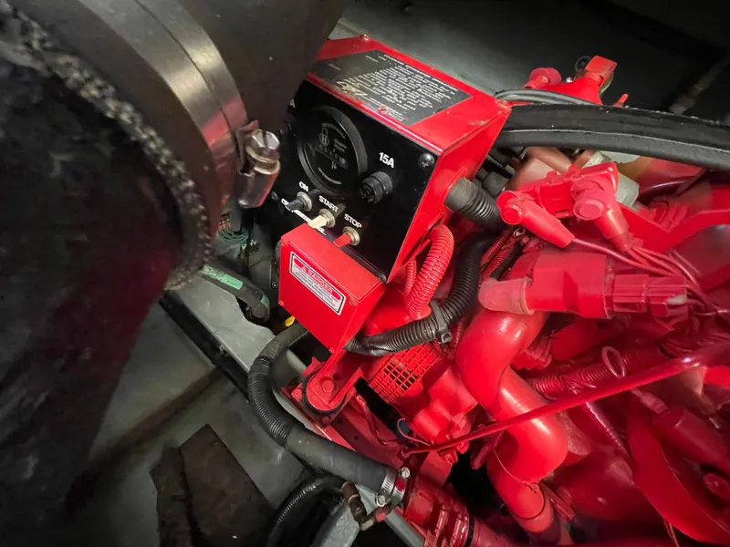 Slide: The Image of Engine compartment of a 1998 Sea Ray 310 boat, featuring red components and wiring. - 17