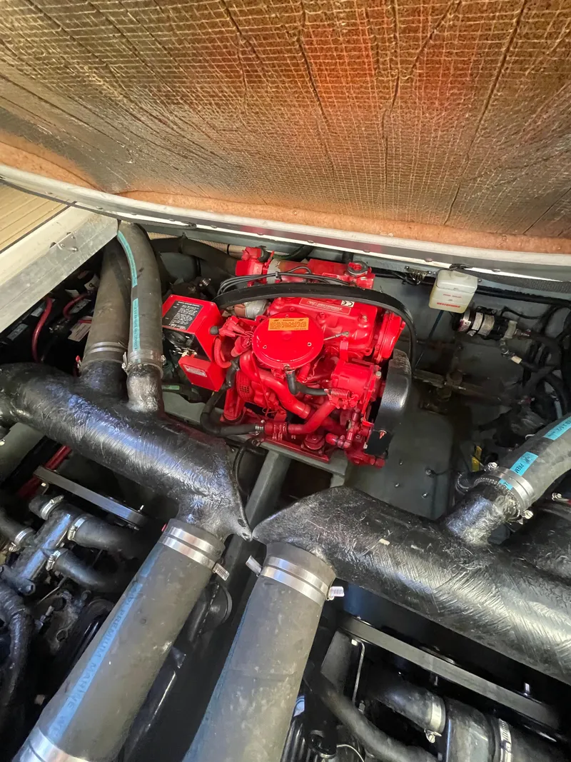 Slide: The Image of Engine compartment of a 1998 Sea Ray 310 boat, featuring a red engine. - 19