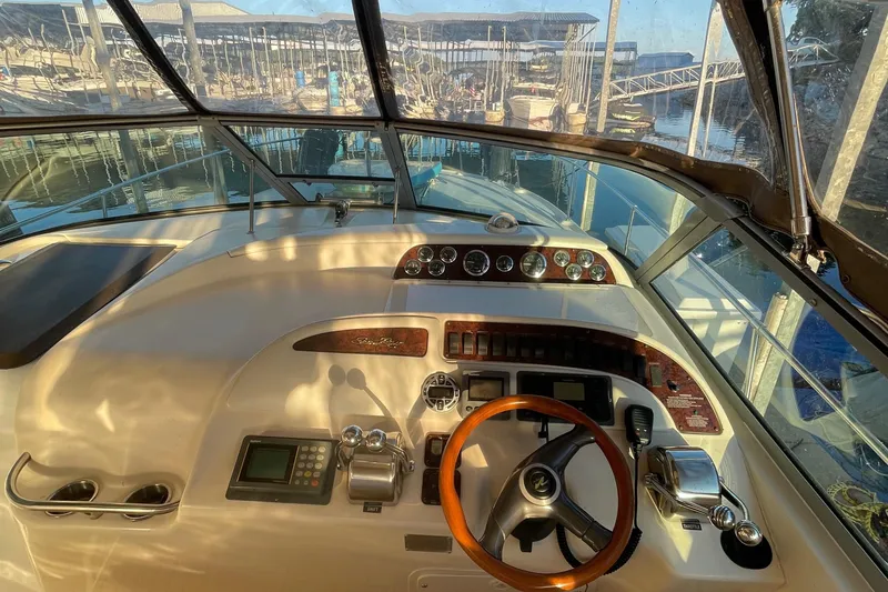 Slide: The Image of Cockpit view of 1998 Sea Ray 310 boat with steering wheel and controls. - 6