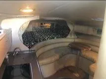 Slide: The Image of Interior of 1998 Sea Ray 310 boat with cozy seating and table. - 9