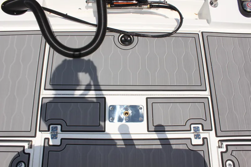 Slide: The Image of 2024 Avid 19 FSX boat deck with gray non-slip surface and hardware. - 12