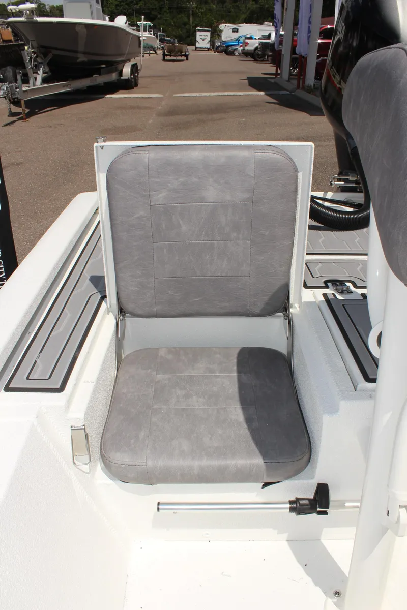 Slide: The Image of 2024 Avid 19 FSX boat seat with gray upholstery, outdoor setting. - 14