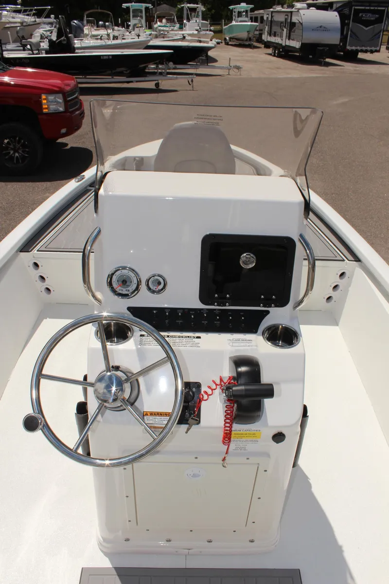 Slide: The Image of 2024 Avid 19 FSX boat console with steering wheel and controls. - 17