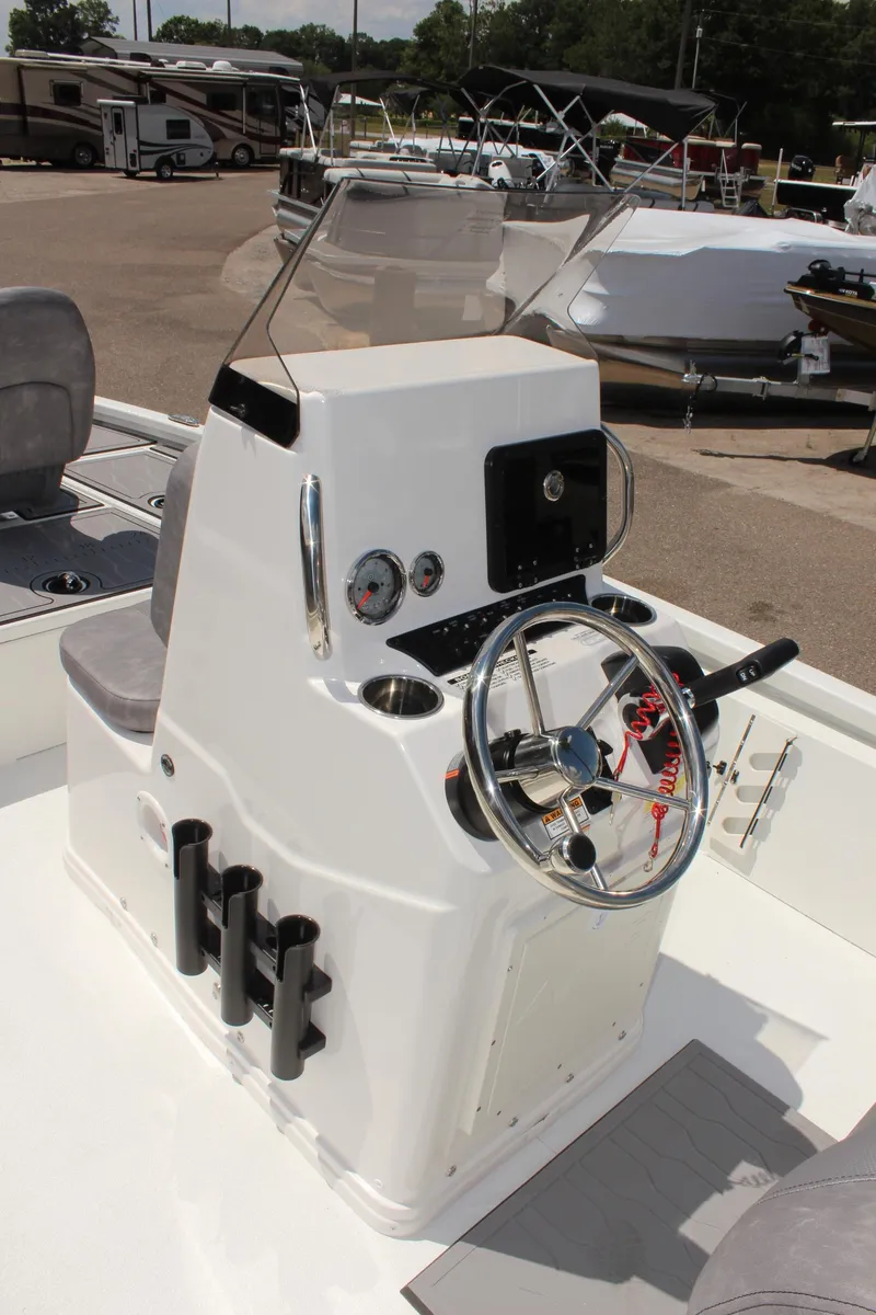 Slide: The Image of 2024 Avid 19 FSX boat console with steering wheel and controls. - 18
