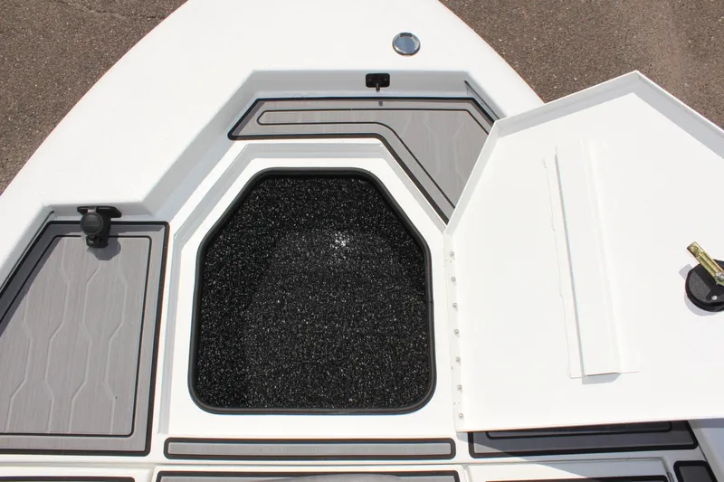 Slide: The Image of 2024 Avid 19 FSX boat storage compartment with open hatch, showcasing interior design. - 26