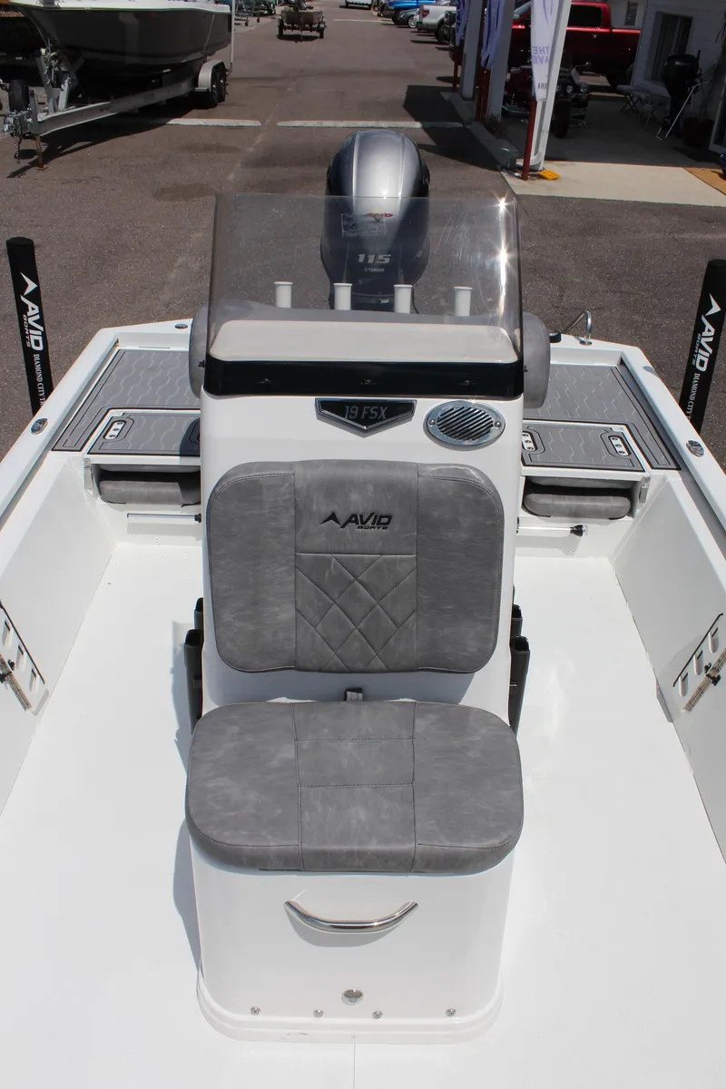 Slide: The Image of 2024 Avid 19 FSX boat interior with gray seating and console. - 27