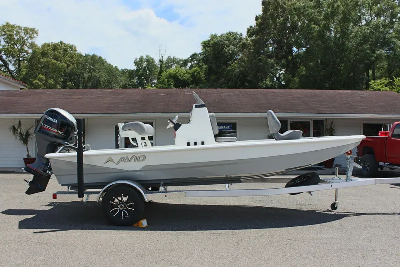 Slide: The Image of 2024 Avid 19 FSX boat on trailer, parked outdoors. - 5