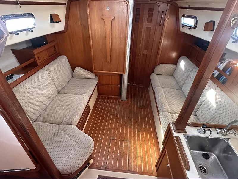 Slide: The Image of Interior of 2001 Island Packet 320 sailboat with wooden finish and cozy seating. - 12