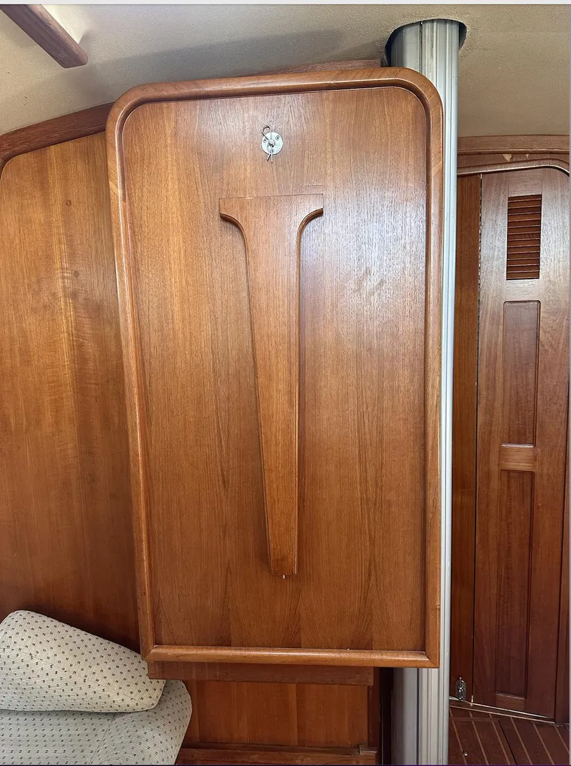 Slide: The Image of Interior of 2001 Island Packet 320 sailboat with wooden cabinetry and seating. - 19