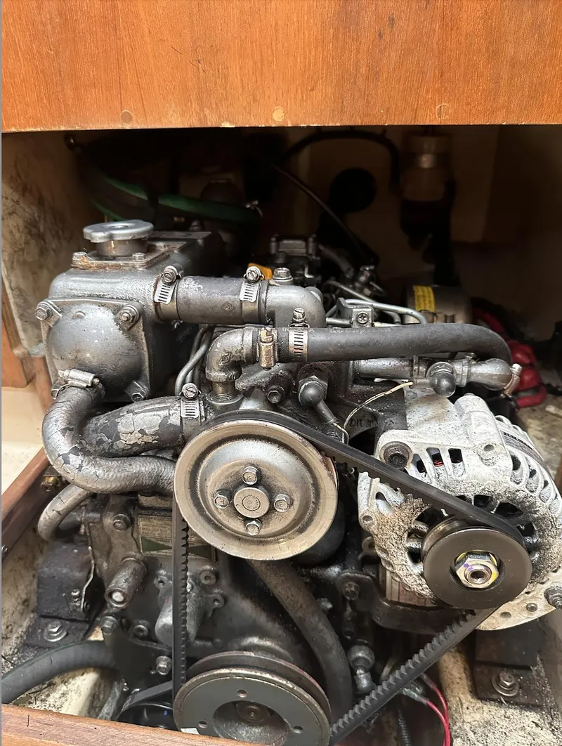 Slide: The Image of Engine compartment of a 2001 Island Packet 320 sailboat, showcasing mechanical components. - 21