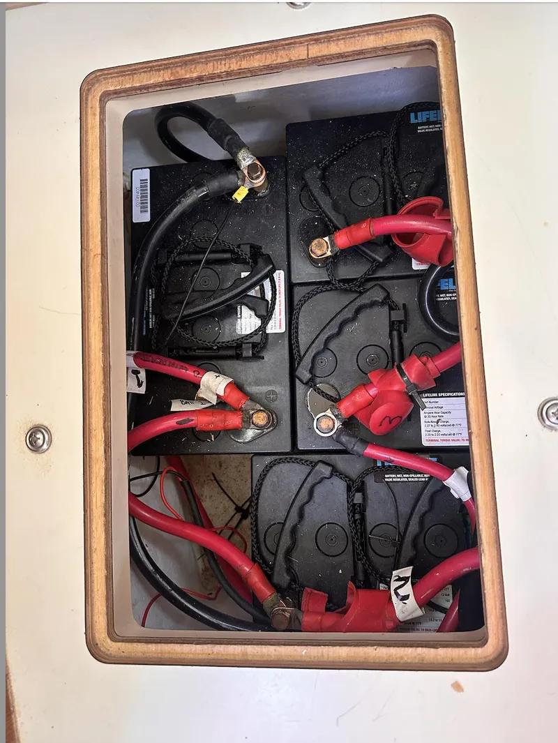 Slide: The Image of Battery compartment of a 2001 Island Packet 320 sailboat with wiring connections. - 22