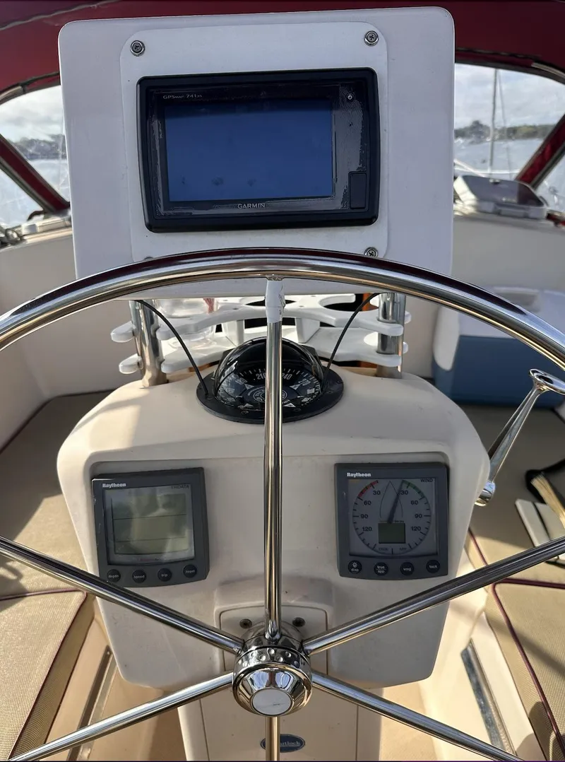Slide: The Image of Steering wheel and navigation instruments on a 2001 Island Packet 320 sailboat. - 9