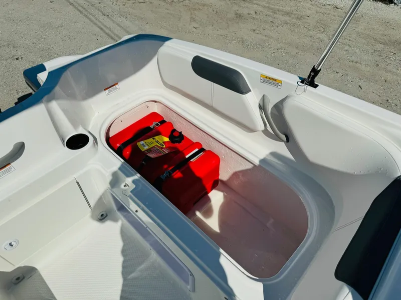 Slide: The Image of 2025 Bayliner Element E18 boat storage compartment with red fuel tank. - 11