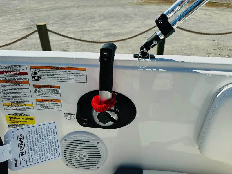 Slide: The Image of 2025 Bayliner Element E18 boat controls with safety warnings and speaker. - 18