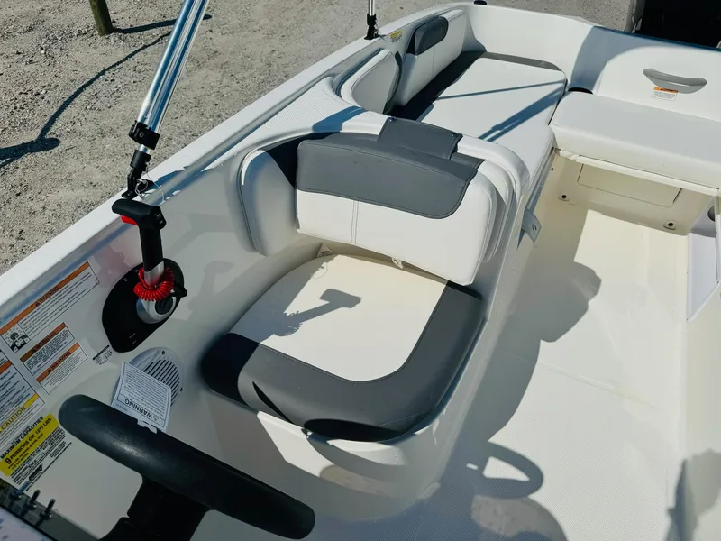 Slide: The Image of 2025 Bayliner Element E18 boat interior with steering wheel and seating. - 19