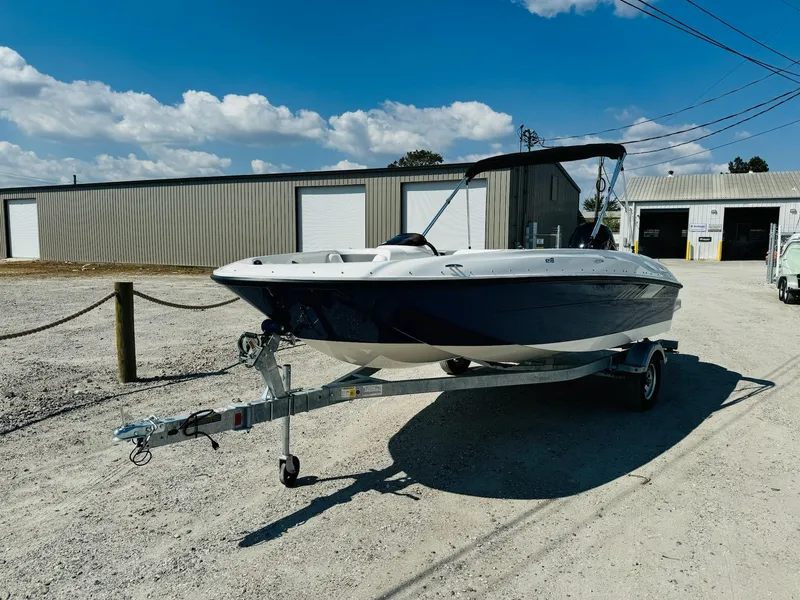 Slide: The Image of 2025 Bayliner Element E18 boat on trailer, parked outdoors under a clear sky. - 2
