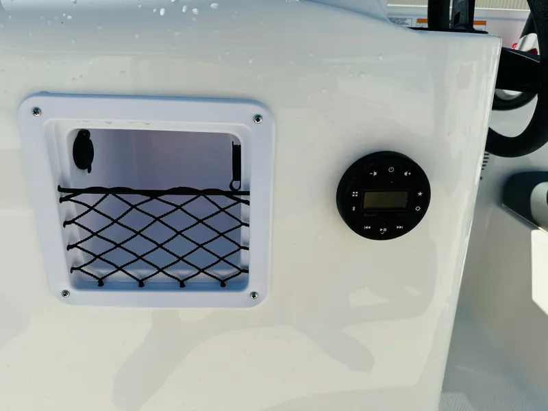 Slide: The Image of 2025 Bayliner Element E18 dashboard with storage net and control panel. - 22