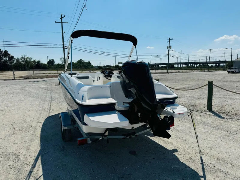 Slide: The Image of 2025 Bayliner Element E18 boat on trailer in sunny outdoor setting. - 8
