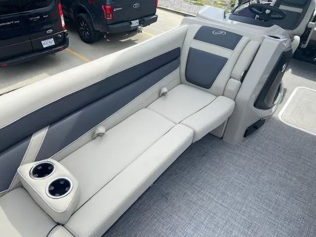 Slide: The Image of 2023 Barletta Cabrio 24 UC boat interior with gray seating and cup holders. - 11