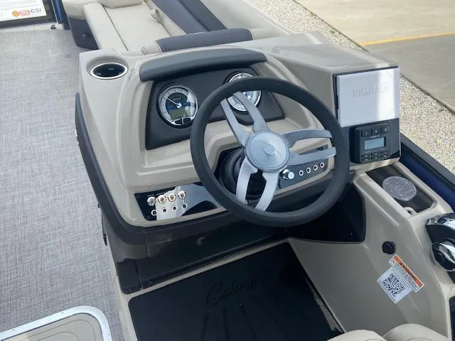 Slide: The Image of 2023 Barletta Cabrio 24 UC boat dashboard with steering wheel and control panel. - 16