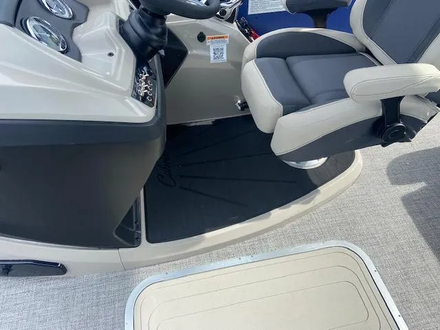 Slide: The Image of 2023 Barletta Cabrio 24 UC boat interior with captain's chair and control panel. - 18