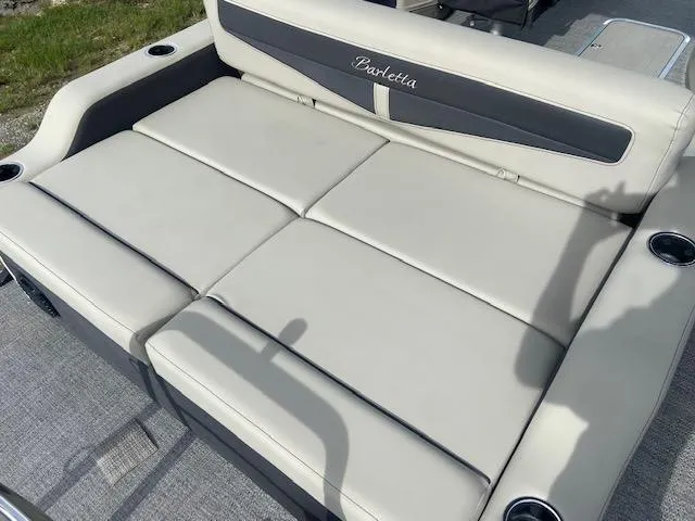 Slide: The Image of 2023 Barletta Cabrio 24 UC boat seating with cup holders, featuring light gray upholstery. - 19