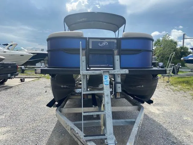 Slide: The Image of 2023 Barletta CABRIO 24 UC pontoon boat on trailer, parked outdoors. - 4