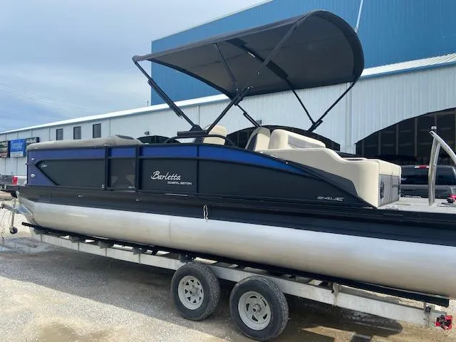 Slide: The Image of 2023 Barletta Cabrio 24 UC pontoon boat on trailer, featuring a sleek design and canopy. - 5