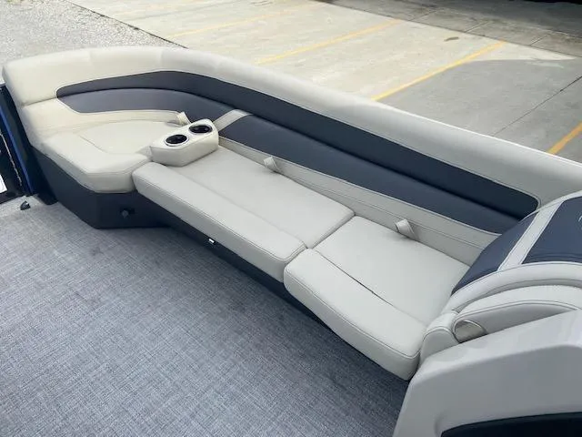 Slide: The Image of 2023 Barletta CABRIO 24 UC boat interior with plush seating and cup holders. - 8