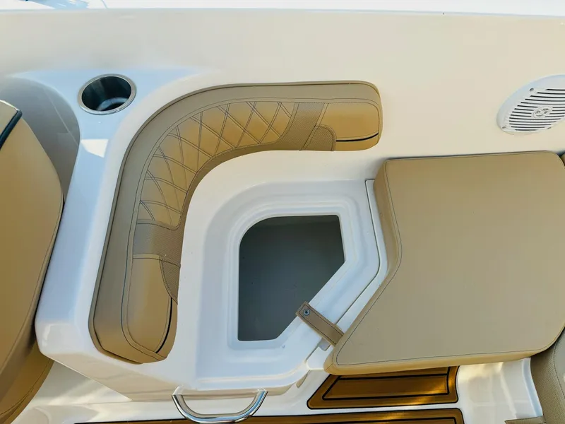 Slide: The Image of 2025 Bayliner VR6 Bowrider OB interior seating with storage compartment and cup holder. - 15