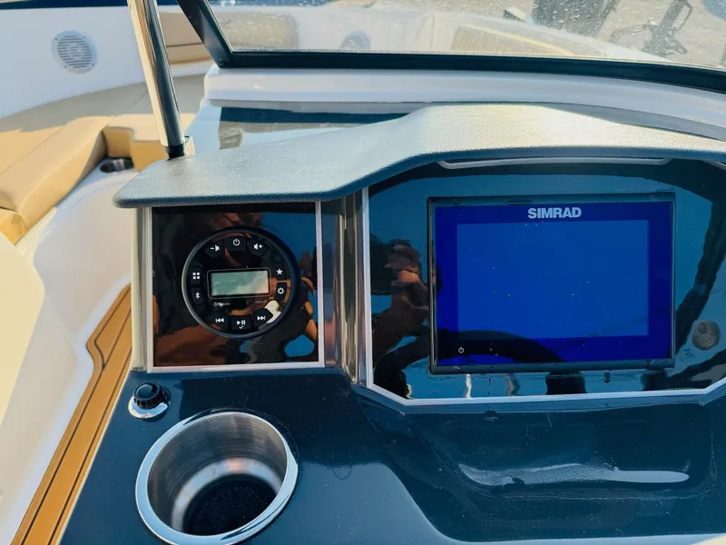 Slide: The Image of 2025 Bayliner VR6 Bowrider OB dashboard with Simrad display and control panel. - 23