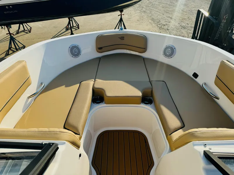 Slide: The Image of 2025 Bayliner VR6 Bowrider OB interior with tan seating and wood accents. - 29